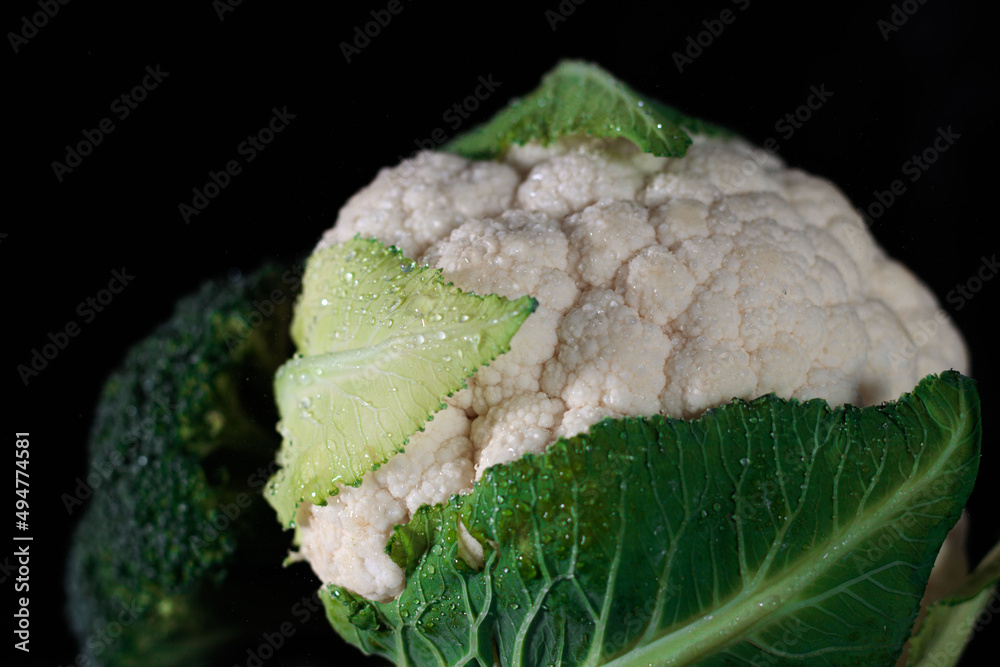 Cauliflower and broccoli in the the dark minimalistic light. Fresh vegetables.
