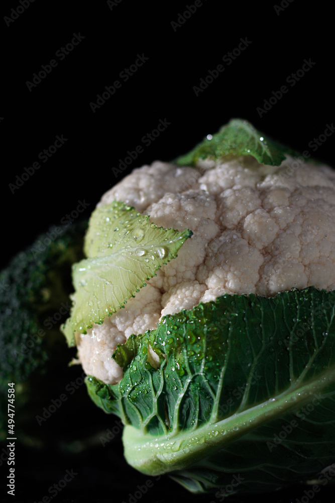 Cauliflower and broccoli in the the dark minimalistic light. Fresh vegetables.