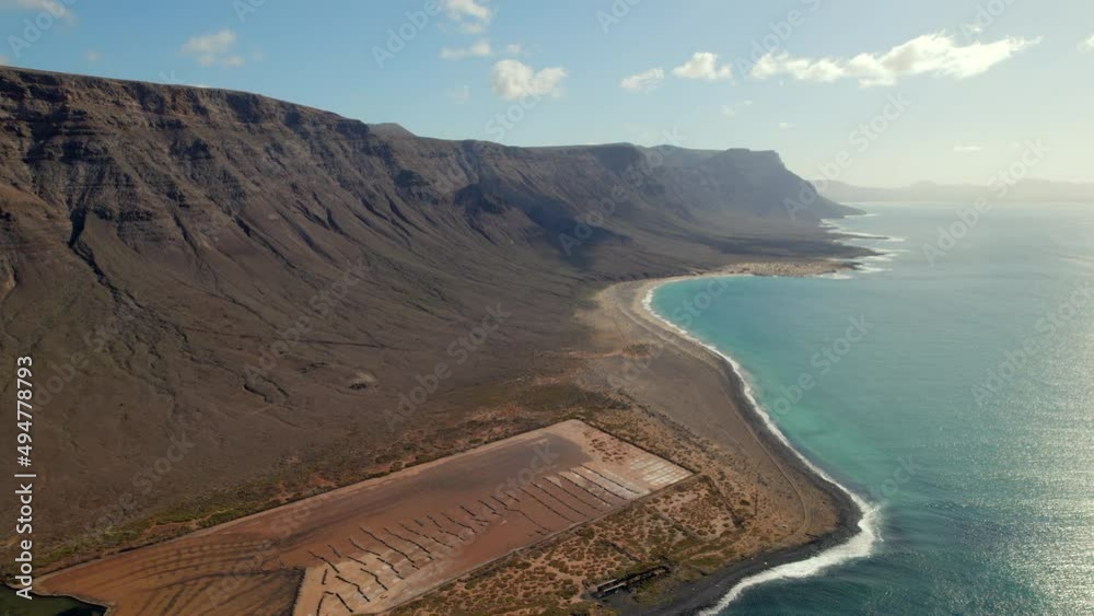 Aerial drone point of view volcanic rocky seaside and Atlantic Ocean of Lanzarote touristic Island, Salinas del Rio. Canaries, Spain