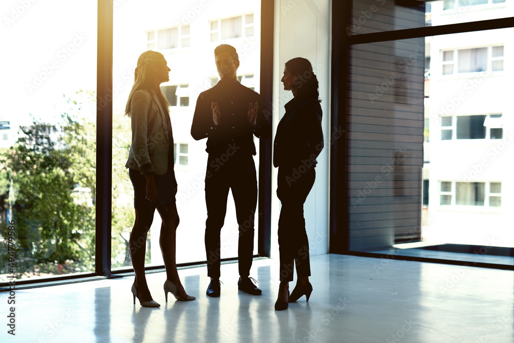 Bringing their bold business vision together. Shot of a group of businesspeople having a discussion in an office.