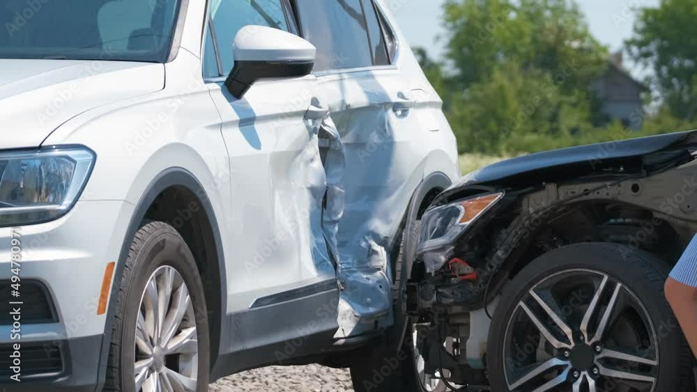 Sad female driver speaking on sellphone on street side calling for emergency service after car accident. Road safety and insurance concept Sad female driver speaking on sellphone on street side calling for emergency service after car accident. Road safety and insurance concept