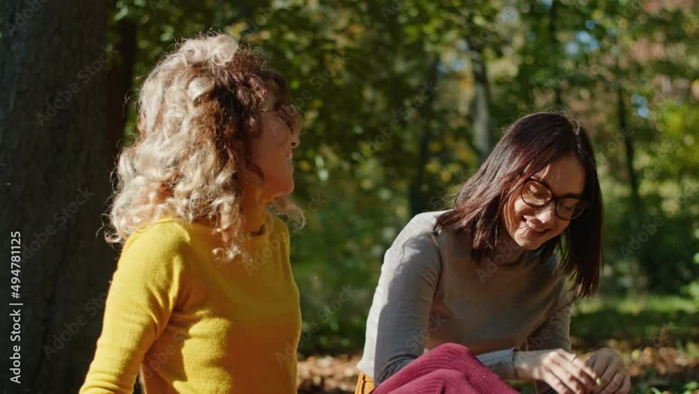 two happy young women have fun sitting in the city park. happy young life. two happy young women have fun sitting in the city park. happy young life.