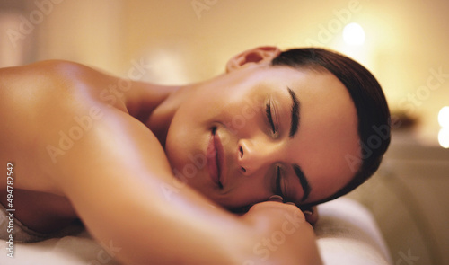 I could lie down on here for eternity. Shot of a beautiful young woman relaxing during a spa treatment.