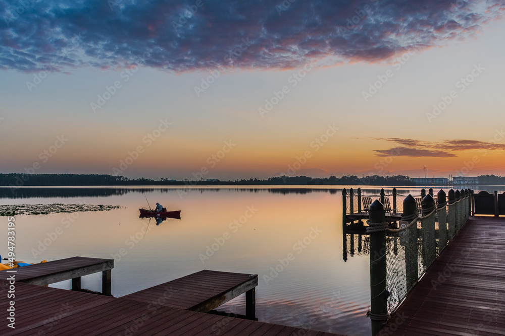 fishing in lake in sunset