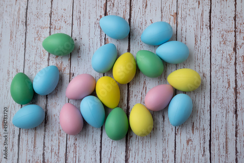 Multicolored easter eggs on wooden background.