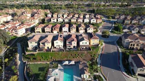 Picturesque, planned residential community with a clubhouse and swimming pool - aerial pullback photo