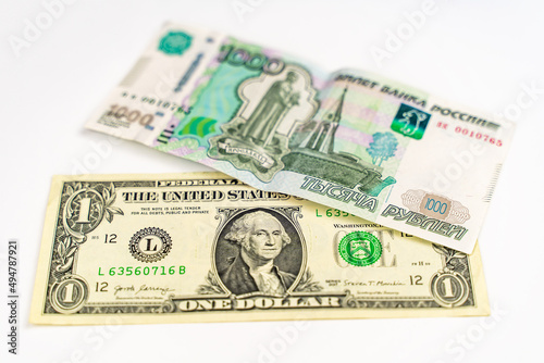 One American dollar and one thousand Russian rubles on a white background. Russian ruble and US dollar exchange rate.