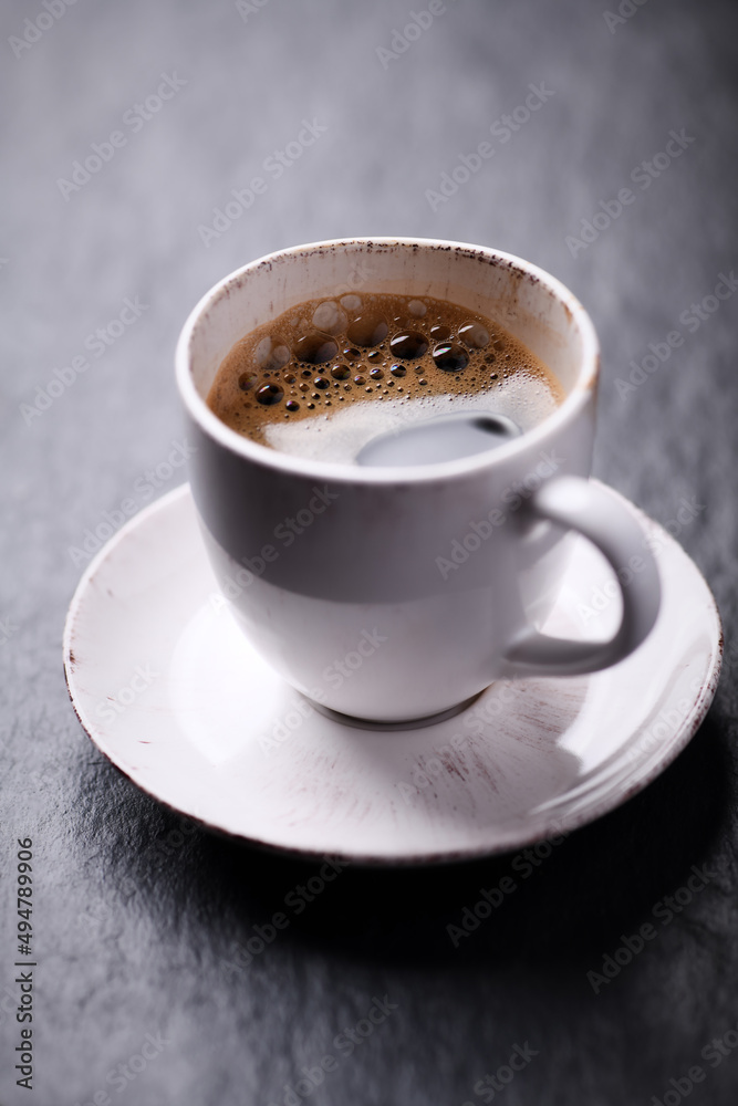 Cup of coffee on dark stone background. Close up. Cup of coffee on dark stone background. Close up.