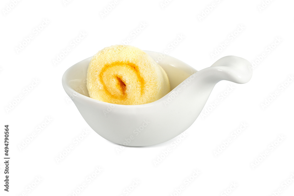 Orange roll cake on white spoon isolated on white background. Clipping path Orange roll cake on white spoon isolated on white background. Clipping path
