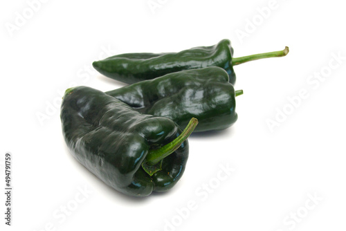 Stack dark green poblano peppers isolated on white  photo