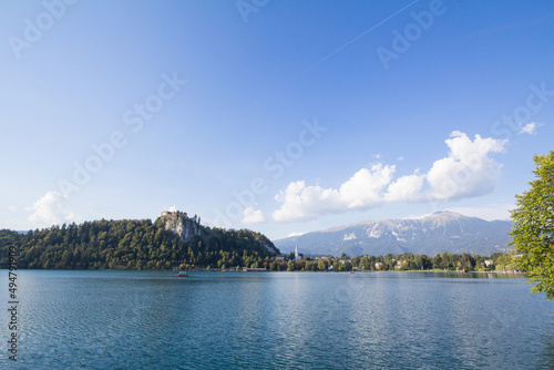 Panorama of the Bled lake, Blejsko Jezero, with its castle, Blejski Hrad and the Saint Martin church, or Cerkev Svetog Martina during a sunny afternoon. Bled Castle is a major monument of Slovenia