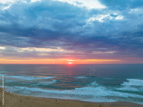 Sunrise reflections and clouds at the seaside with lagoon