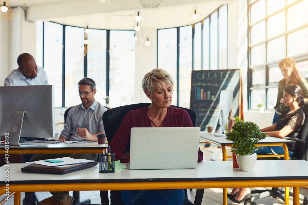 Working hard to grow their business. Shot of designers working in an office.