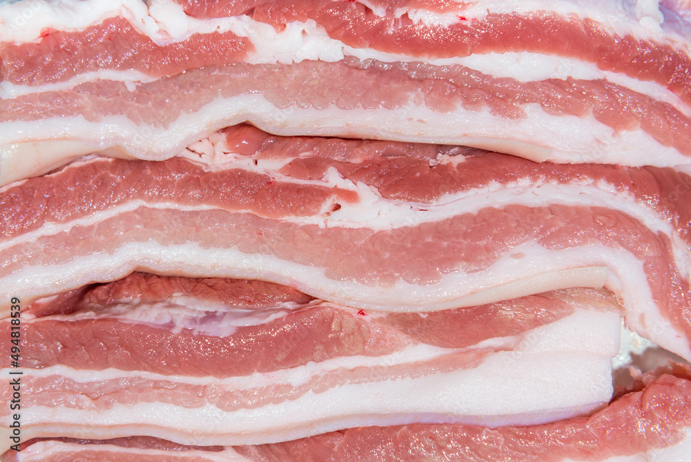 Closeup top view pieces fresh raw meat of pork belly with white fat and red pink meat Closeup top view pieces fresh raw meat of pork belly with white fat and red pink meat