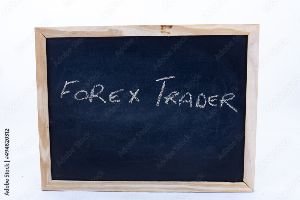 The term FOREX TRADER displayed on a chalkboard The term FOREX TRADER displayed on a chalkboard