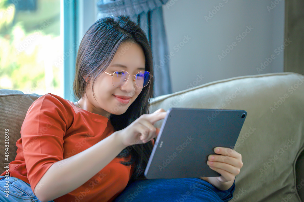 Attractive businesswoman using digital tablet in the house Business concept with modern technology. Attractive businesswoman using digital tablet in the house Business concept with modern technology.