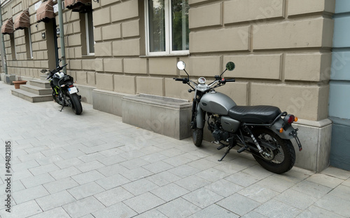 motorcycles are standing against an old stone wall. biker concept