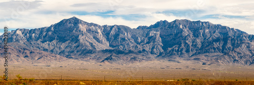 Scenic views in the Mojave Desert on road trip with mountains and desert landscape in foreground. 