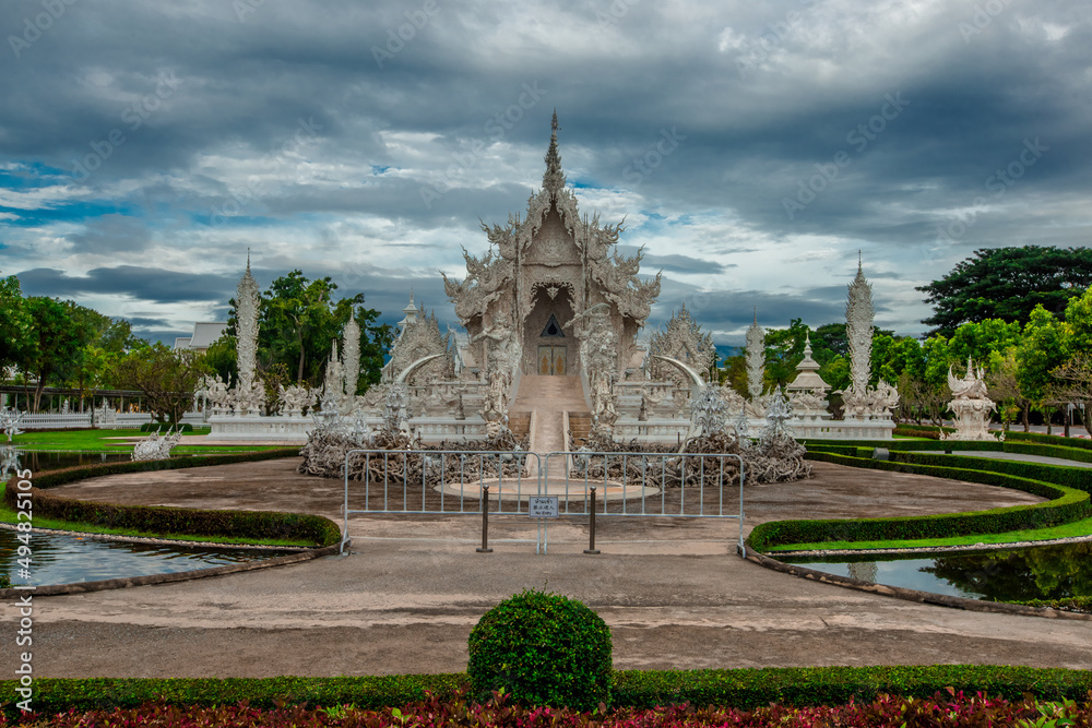background Wat Rong Khun The White Temple and pond with fish, in Chiang Rai, Thailand