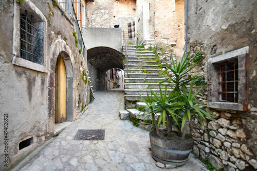 Fototapeta Naklejka Na Ścianę i Meble -  A narrow street among the old stone houses of Taurasi, town in Avellino province, Italy.