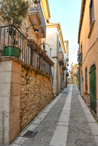 Fototapeta Naklejka Na Ścianę i Meble -  A narrow street among the old stone houses of Taurasi, town in Avellino province, Italy.