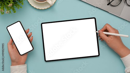 Female college student using smartphone and tablet.