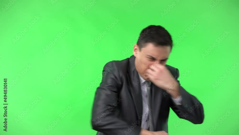 Man in elegant suit pinching nose in studio