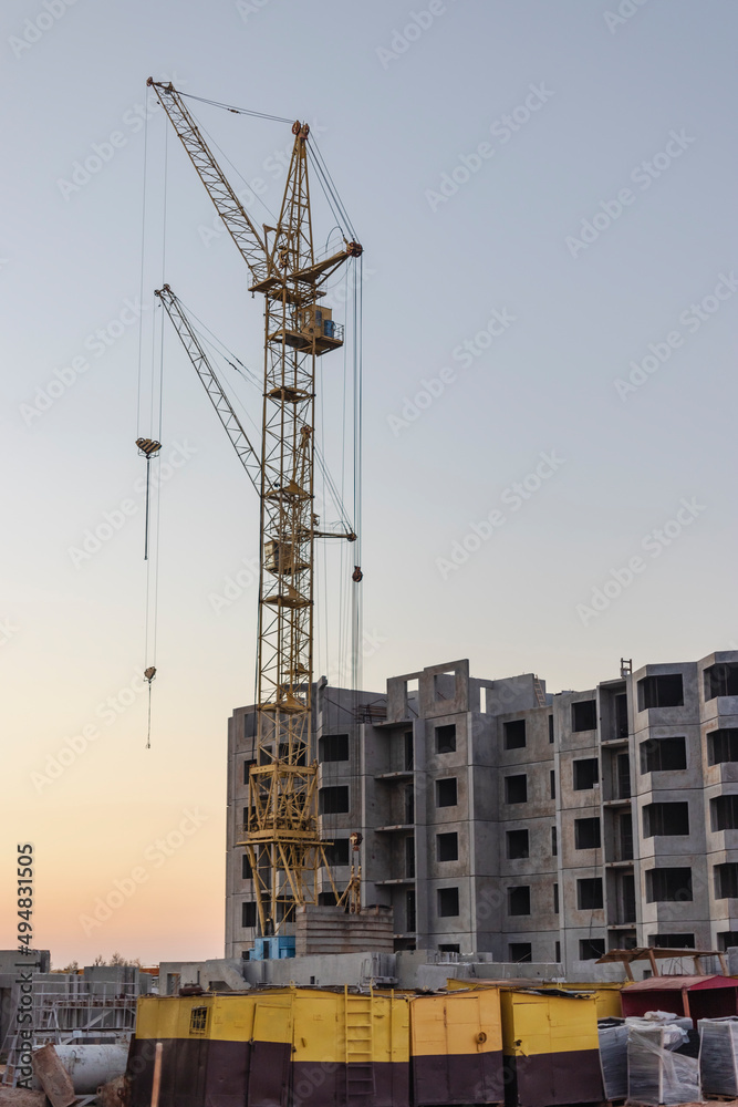 Construction of a multi-storey panel reinforced concrete house. Safe ramp at the entrance to the building. Construction site safety.