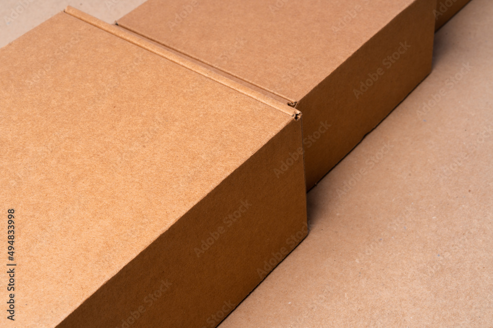Cardboard box on beige background in studio Cardboard box on beige background in studio