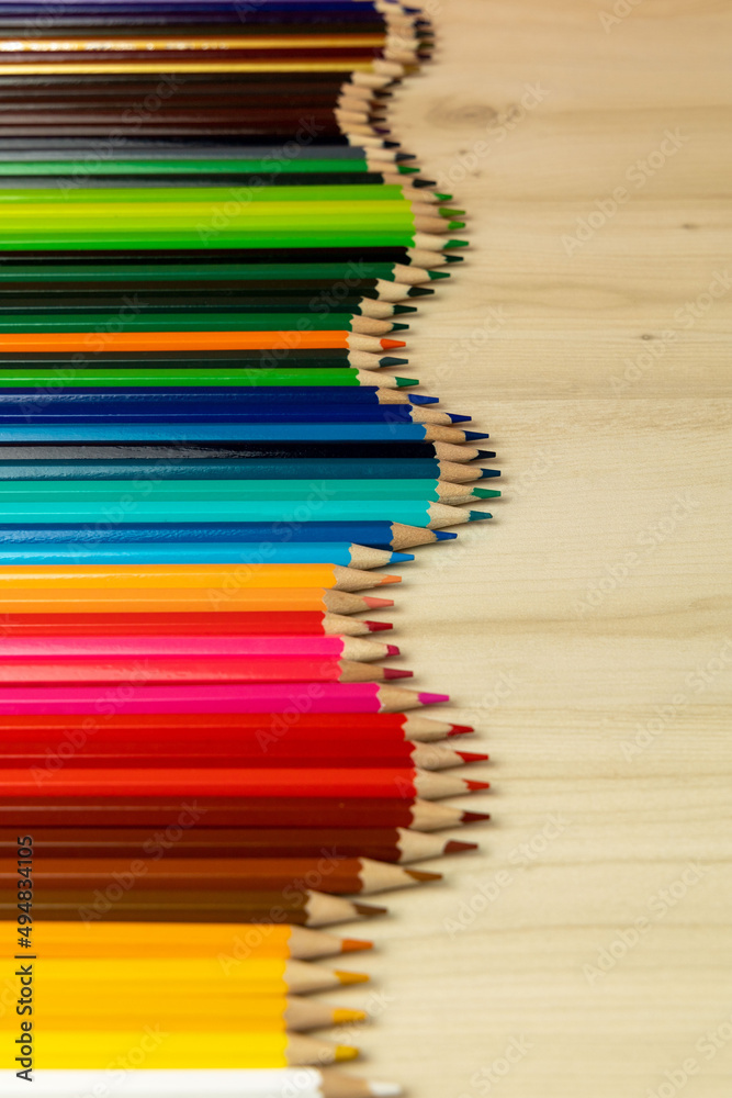 Fototapeta premium Color pencils isolated on wood background.