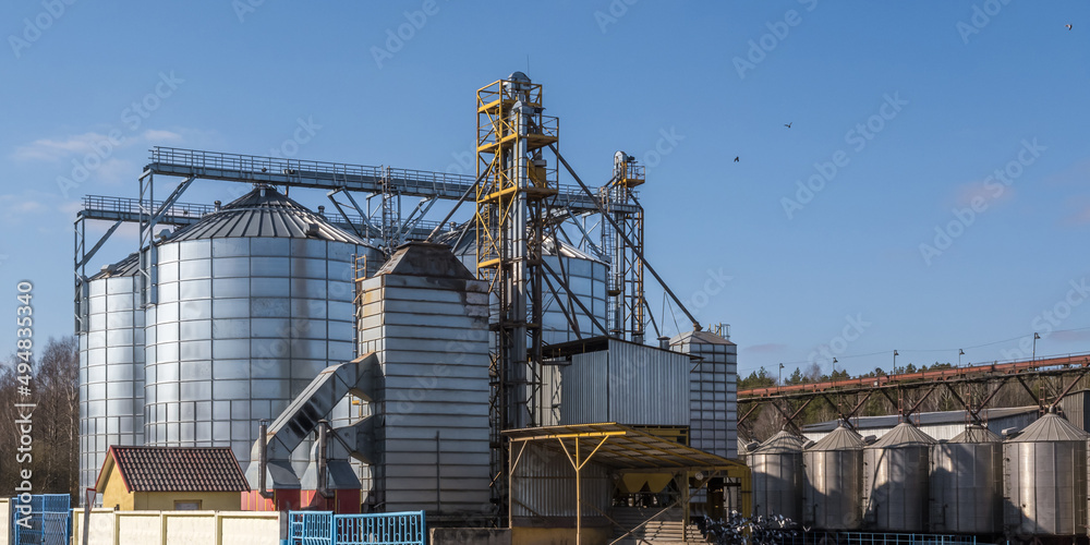 panorama view on agro silos granary elevator on agro-processing manufacturing plant for processing drying cleaning and storage of agricultural products, flour, cereals and grain. panorama view on agro silos granary elevator on agro-processing manufacturing plant for processing drying cleaning and storage of agricultural products, flour, cereals and grain.