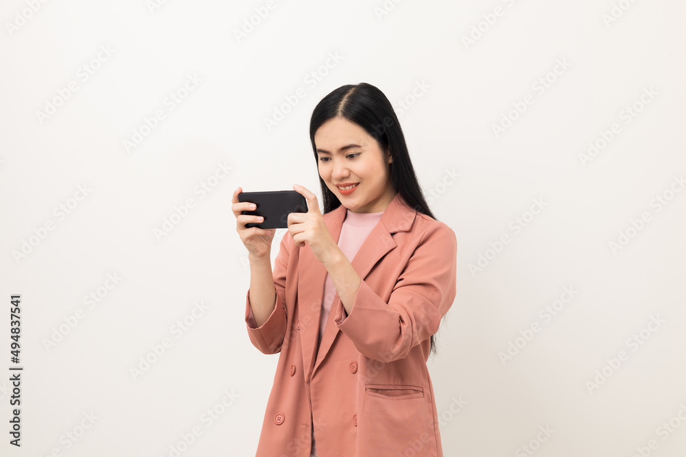 Cheerful young Asian woman using smartphone and checking message on mobile chat application isolated white background. Fashion style asian lovely woman playing game or shopping online by cellphone Cheerful young Asian woman using smartphone and checking message on mobile chat application isolated white background. Fashion style asian lovely woman playing game or shopping online by cellphone