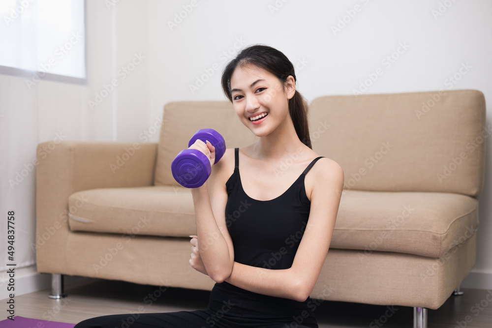 Attractive asian young fitness woman lifting dumbbell weights workout at home in living room. Fresh feeling female training and exercise wearing sport wear fit body. Attractive asian young fitness woman lifting dumbbell weights workout at home in living room. Fresh feeling female training and exercise wearing sport wear fit body.