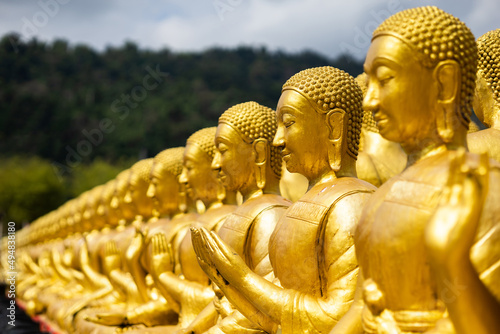 Lot of Golden Statue of Buddha sitting in meditation Belief Faith and Worship concept. Big buddha Press the hands together at chest In sign of respect religion culture