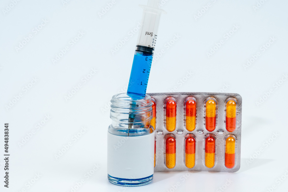 Medical glass jar with syringe and pills isolated on white background. Medicine Medical glass jar with syringe and pills isolated on white background. Medicine