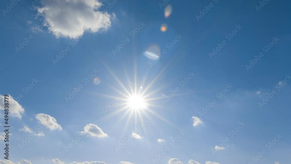 sparkle sun on blue cloudy sky time lapse scene