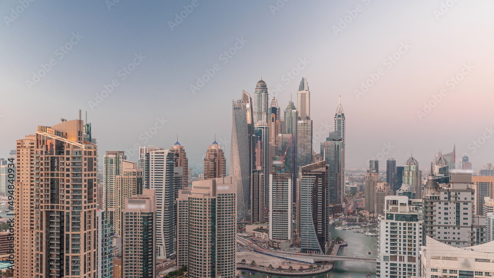 View of various skyscrapers in tallest recidential block in Dubai Marina aerial day to night timelapse