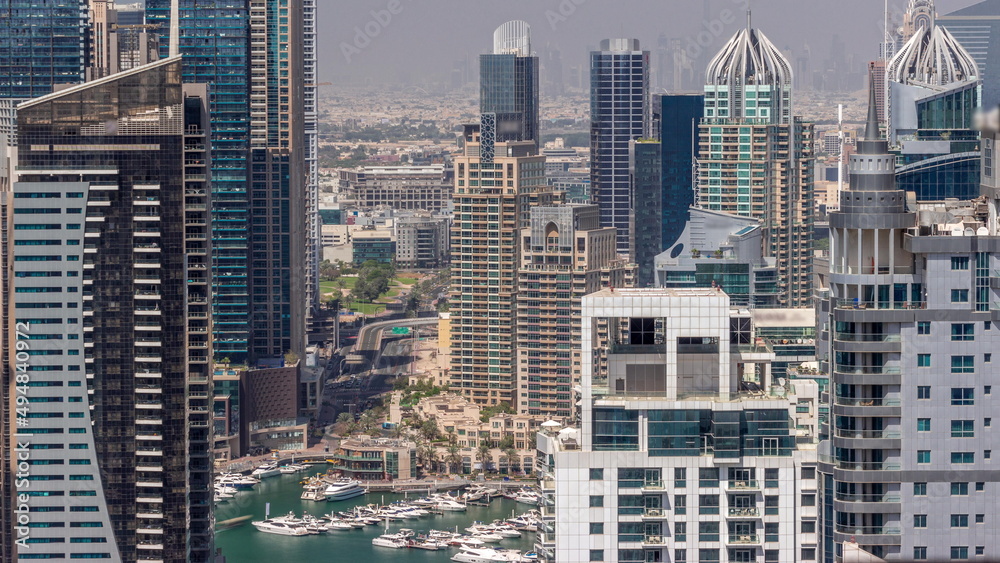Dubai Marina and Media City districts with modern skyscrapers and office buildings aerial all day timelapse.
