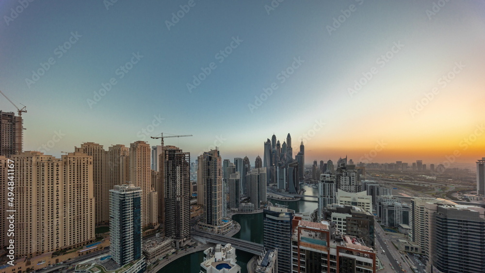 View of various skyscrapers in tallest recidential block in Dubai Marina aerial all day timelapse