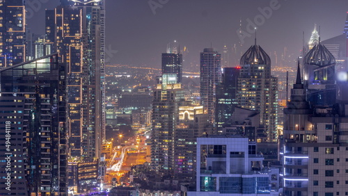 Dubai Marina and Media City districts with modern skyscrapers and office buildings aerial all night timelapse.