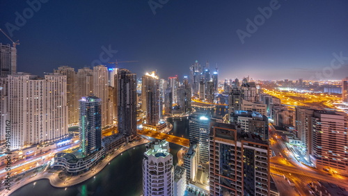 Panorama of various skyscrapers in tallest recidential block in Dubai Marina aerial night to day timelapse © neiezhmakov