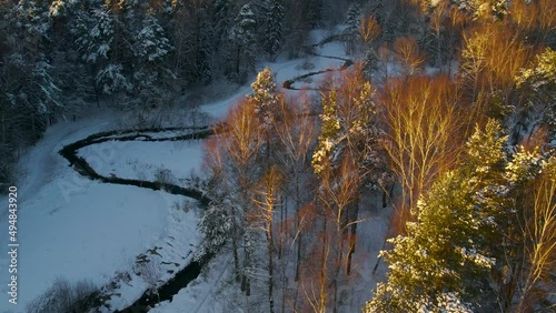 Winter snow-covered coniferous and mixed forest. Top view from a drone