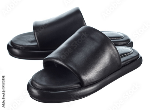 Pair of high-quality black leather sandals isolated on a white background. Comfortable shoes for beach holidays and summer walks. © KPad