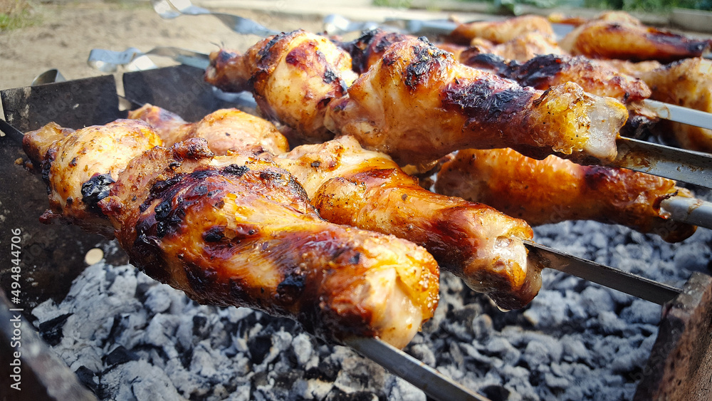 Close-up of grilled chicken meat, fried chicken meat on skewers on the grill