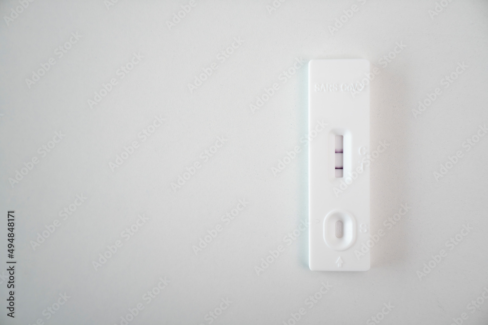 Test kit with Positive result during swab COVID-19 testing. Coronavirus Self nasal or Home test, Lockdown and Home Isolation concept Test kit with Positive result during swab COVID-19 testing. Coronavirus Self nasal or Home test, Lockdown and Home Isolation concept