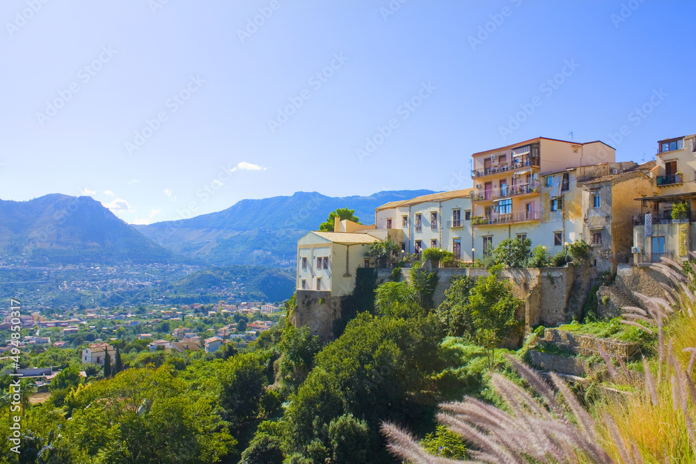 View of Old Town in front of mountains in Monreale, Sicily, Italy