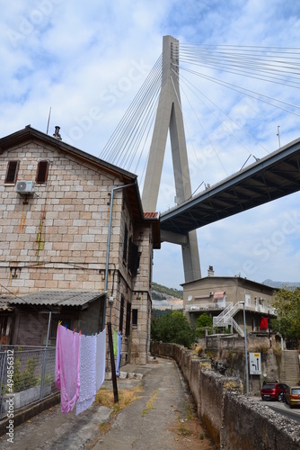 Modern bridge on the background of old houses