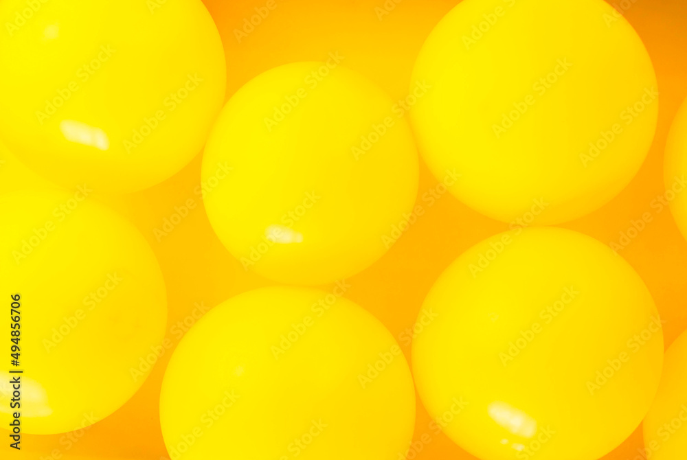 Group of yellow balloons create a background.
