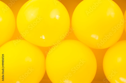 Group of yellow balloons create a background.