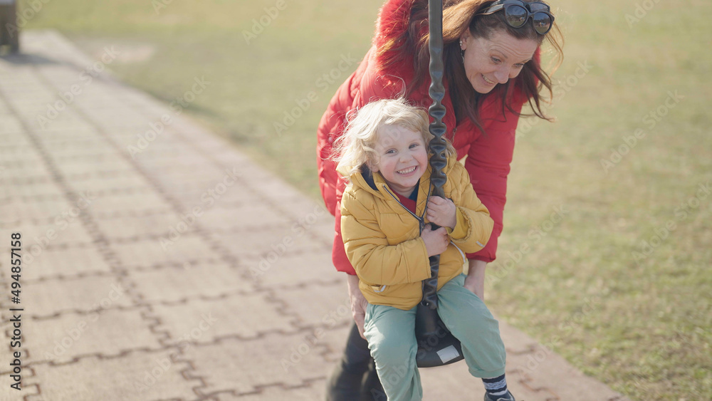 Fototapeta premium Grandmother and grandchild laughing on a zip line enjoy time together